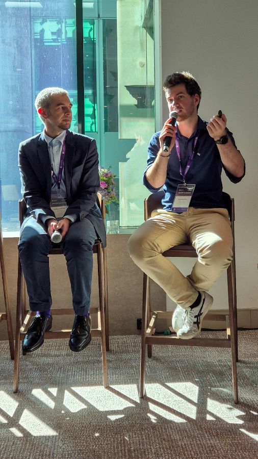 UQ professor Gianluca Demartini (left) and Fann Bachmann, PhD candidate from UZH, talk about the role of AI in democracy.